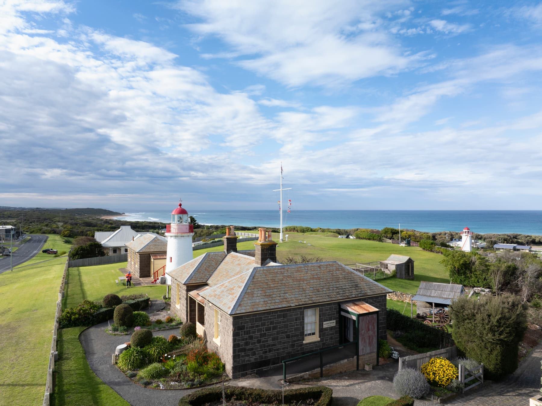 Lighthouse and attached buildings overlooking seascape