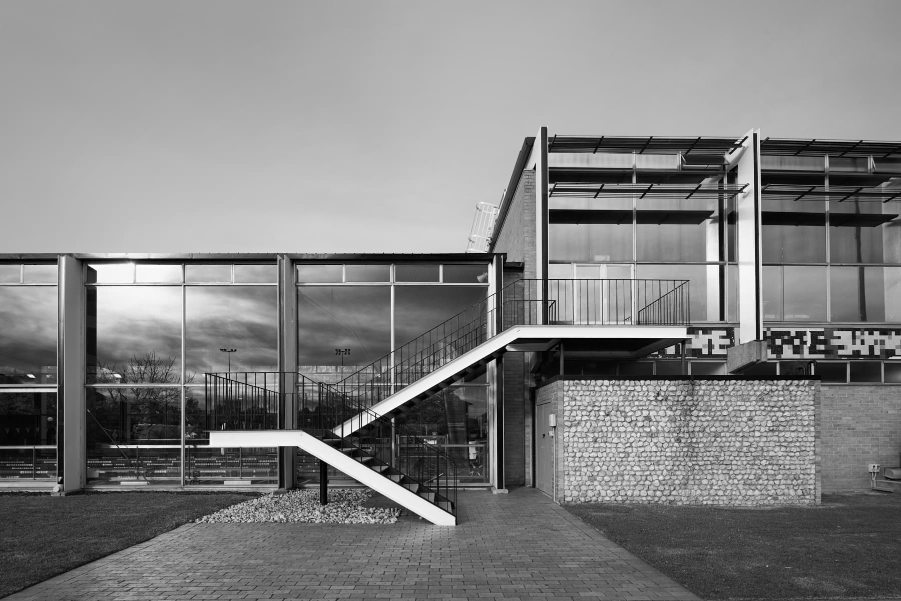 Black and white photograph of The Beaurepaire Centre featuring glass façade and concrete elements.