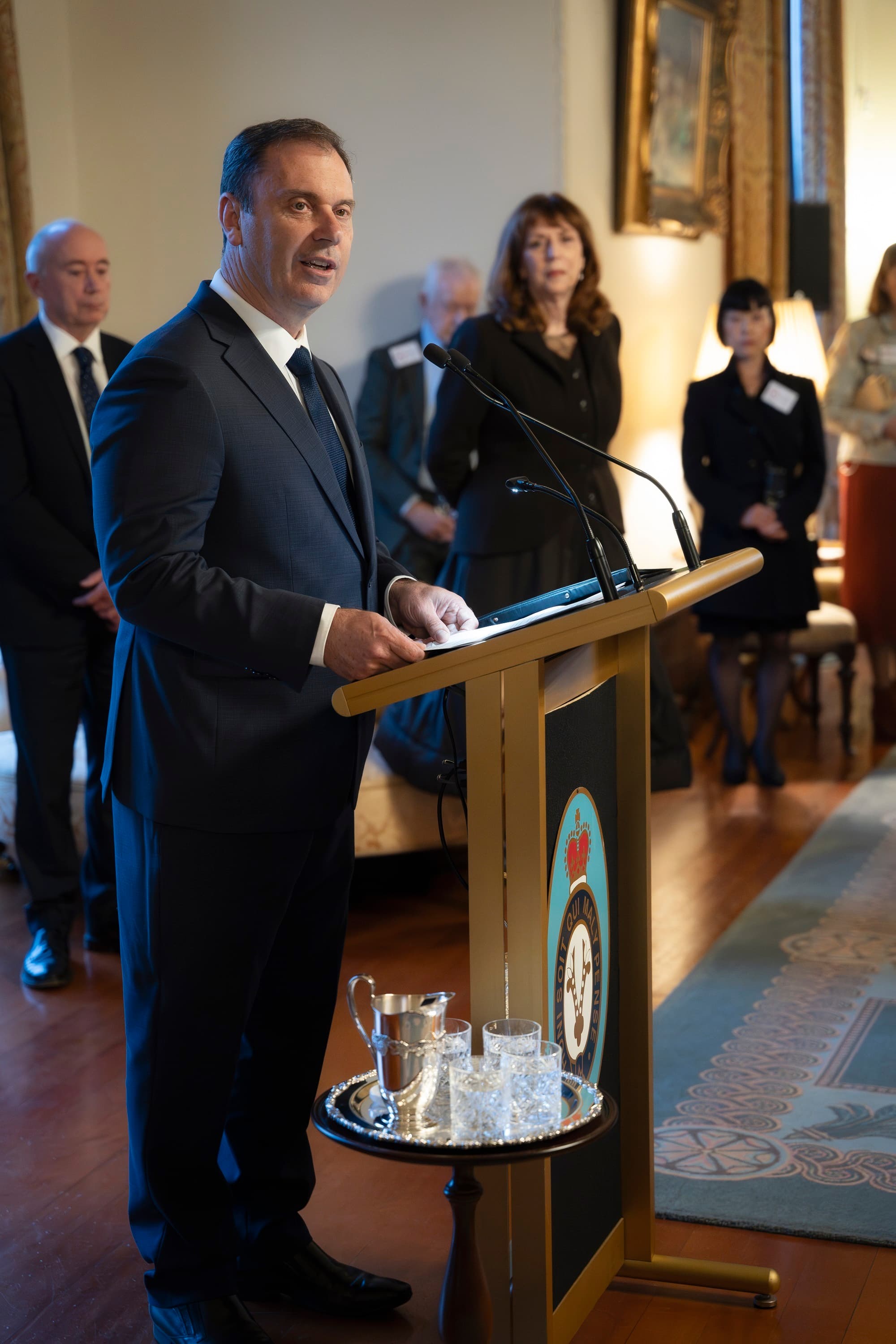 The Hon. Colin Brooks, Minister for Development Victoria, Minister for Precincts, and Minister for Creative Industries giving speech at podium