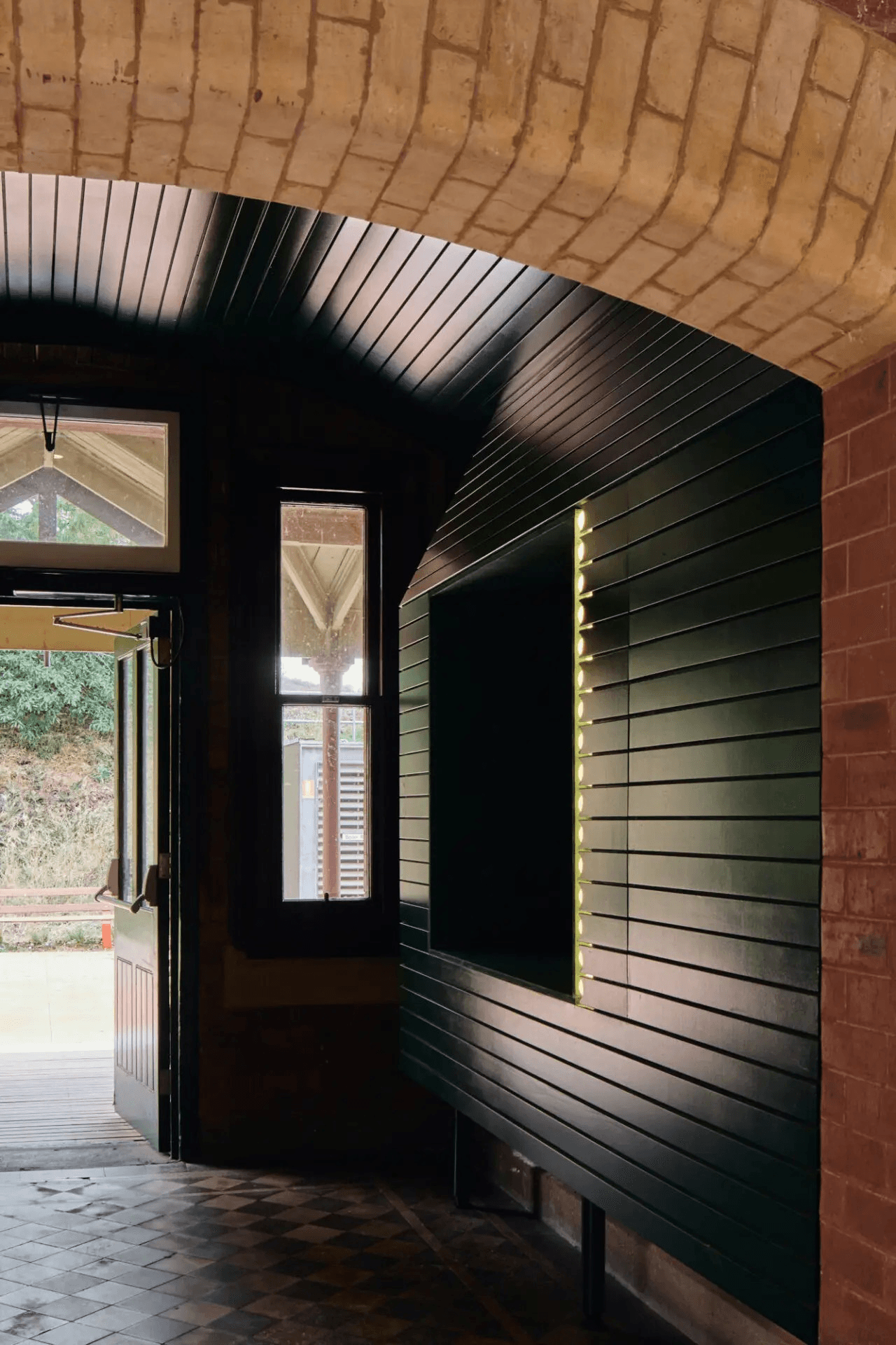 Brick and painted wood panelling in hallway